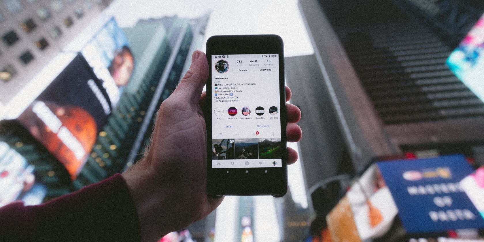 Photo of person holding smartphone with Instagram open in window