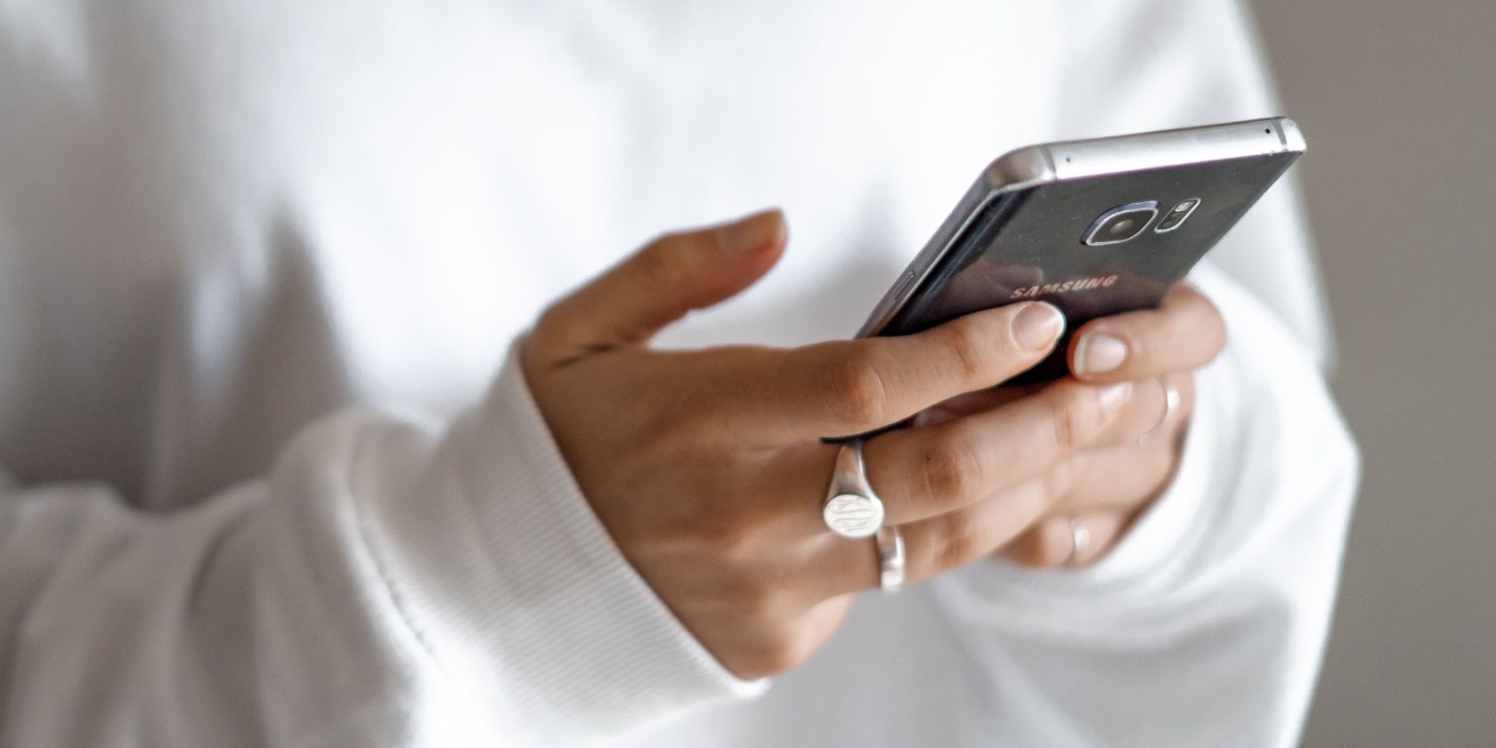 woman sending text messages to an Android phone